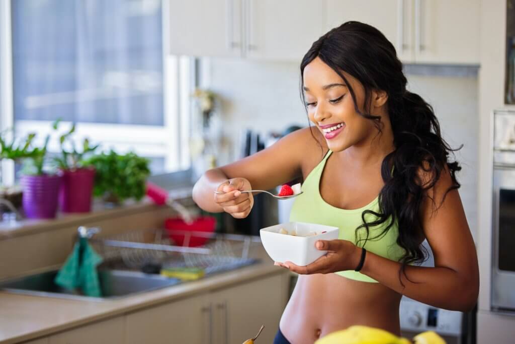Woman eating healthy food, fruit, salad
