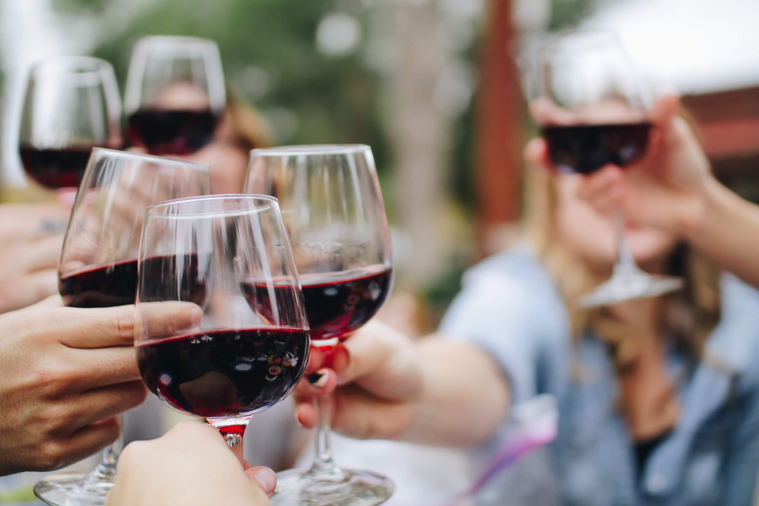 People toasting glasses of red wine